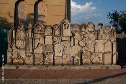 Canvas Print Memorial wall of fragments of ancient Jewish gravestones matzevot with Hebrew in