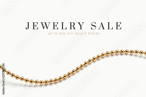 A minimalist promotional graphic features bold black text advertising a jewelry sale with a discount offer presented above a elegantly curved string of shiny golden beads