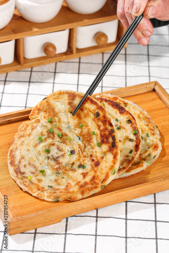 Photography Chinese Scallion Pancakes with Chopsticks on Wooden Serving Board - Traditional