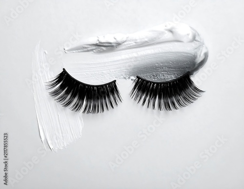 Fluffy Black Lashes for Elegant Eye Makeup on Soft Gray Background, Voluminous Beauty Cosmetic Enhancement with Glamorous Fashion Style