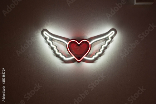 Neon heart with wings sign