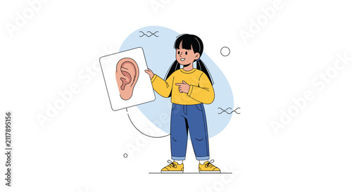 Cute young schoolgirl pointing to a detailed diagram of a human ear during a biology or science class presentation.