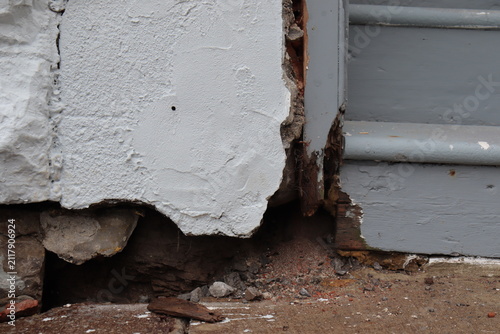Outdoor old brick wall background. Old house problem and hole in the facade. House renovation and foundation crack. Construction industry and outdoor renovation for old house.