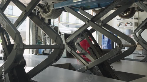Car on a Hydraulic Lift at an Auto Service Center