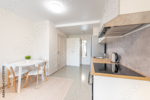 Modern Home Kitchen With White Cabinets and Appliances in Bright Surroundings