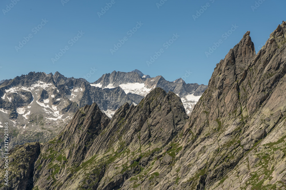 Fototapeta premium Guttannen, Switzerland. Close-up panorama of rugged granite mountain ridges and alpine glaciers viewed from Gelmerseehütte in the Bernese Alps