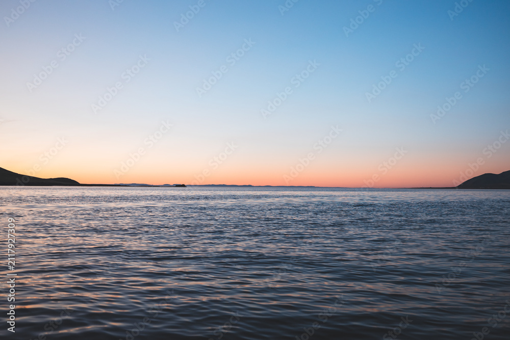 Obraz premium calm Icelandic seascape beneath a soft blue and pink twilight sky