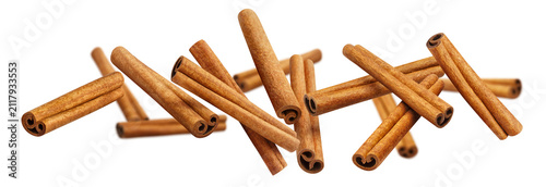 Photography Natural rolled cinnamon spice scattered in weightless motion, isolated on transp