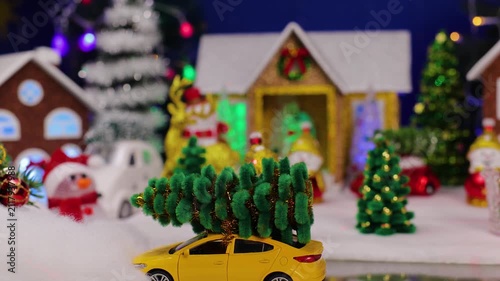 A yellow car drives up to the decorated Christmas town
