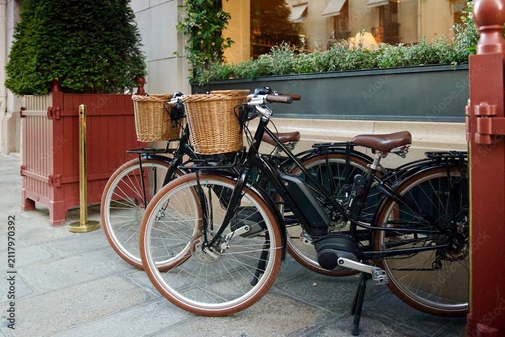 Fototapeta premium pair of matching bicycles on the sidewalk