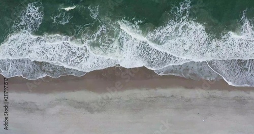 Aerial view of ocean waves in constant motion as they create mesmerizing patterns across the water surface.