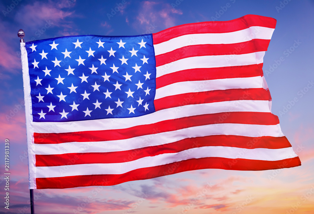 Fototapeta premium Flag of United States of America against sunset sky
