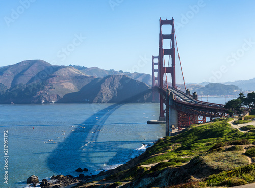 The landmark Golden Gate Bridge spans the entrance to the Pacific Ocean near the coastal hills of Marin County California.