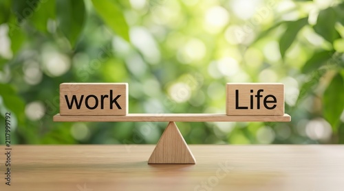 Wooden blocks spelling work and life on a balance scale for work-life balance concept.