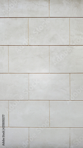 Light beige stone wall background with rectangular masonry pattern. Neutral natural texture. Clean seamless-looking surface with soft tones and minimal visual distractions.