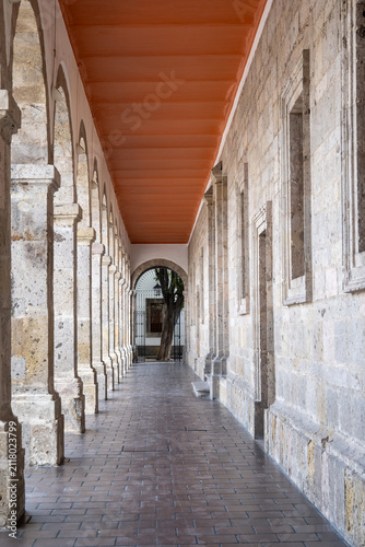 Captivating long stone archway corridor within the historic Cabanas Cultural Center in Guadalajara. Detailed old architecture.