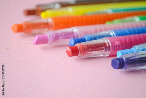 Colorful felt tip pens. Back to school colorful twistable crayons and wax crayons on pink background