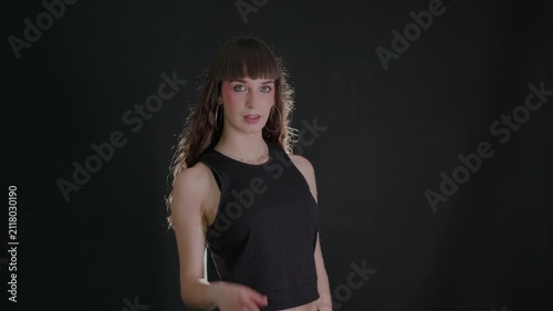 Confident young woman pointing finger at camera
