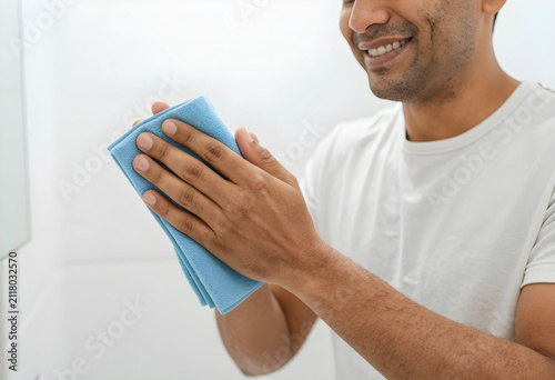 Smiling man cleaning a surf...