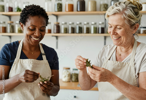 Two smiling women in aprons...