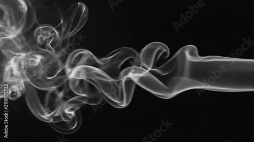 Abstract white smoke swirls gracefully against a deep black background