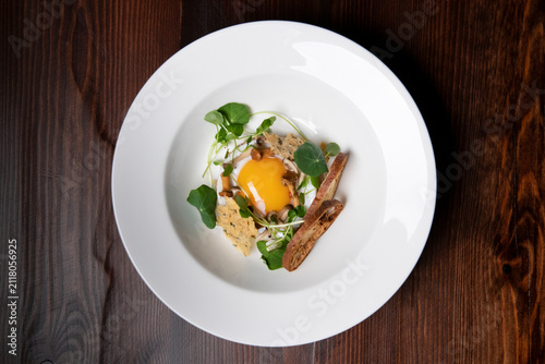 Photography Delightful Culinary Creation Featuring Egg Yolk and Crispy Accents on Wooden Tab
