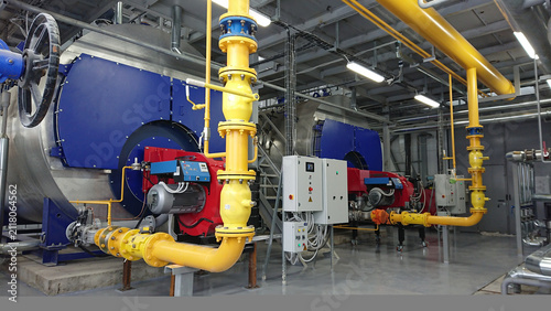 Cuadro en lienzo Industrial boiler room facility featuring large heating units and network of yel