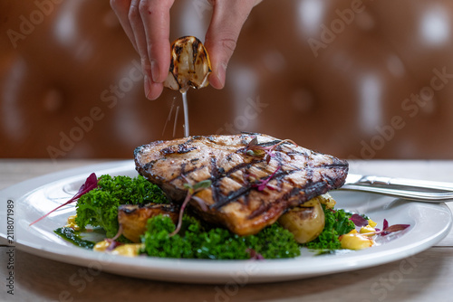 Culinary Artistry Unfolds With Grilled Fish and Fresh Ingredients on a Plate