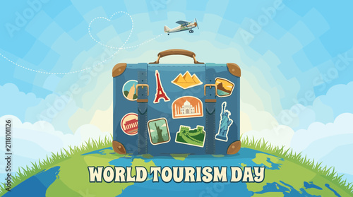Suitcase on globe for World Tourism Day.