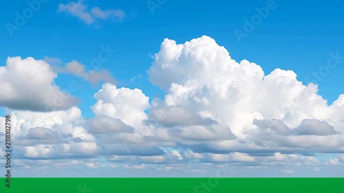 Expansive Blue Sky with Fluffy White Clouds Over a Verdant Green Horizon on a Bright Summer Day