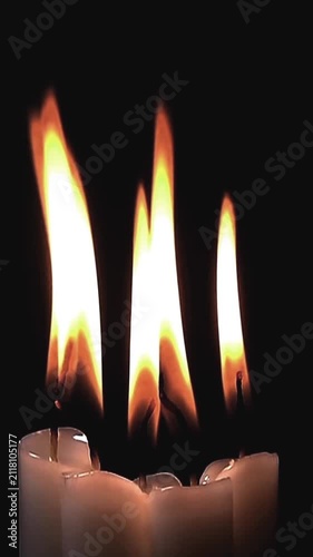 Burning White Candles with Glowing Flames on Black Background