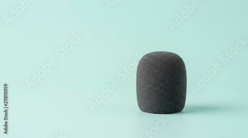 Minimalist Studio Portrait of a Foam Microphone Windscreen on Pastel Background