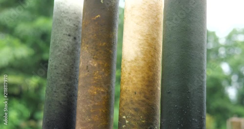 Four dirty used water filter cartridges comparison with natural background
