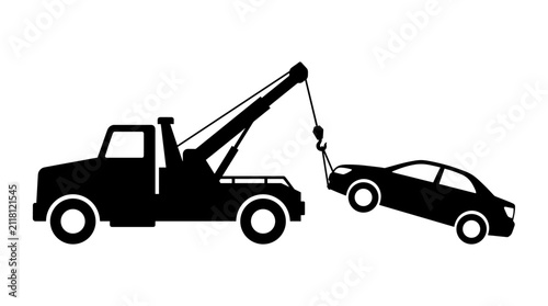 Fotografía Tow truck hauling broken down car silhouette