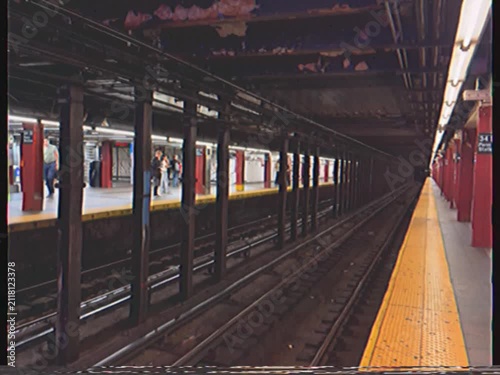 Subway train with american flag passing through the 34th street penn station in manhattan, new york city with a vintage vhs effect, showcasing urban transportation and commuting
