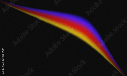 Abstract light streak with vibrant gradient colors of yellow, red, and blue on a black background