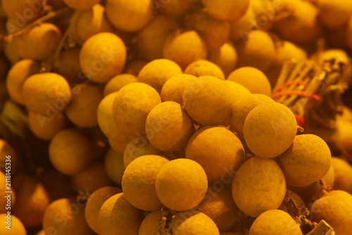 Fresh Longan Berry Bunches Macro Background Fruit Market Stall. Background and texture.