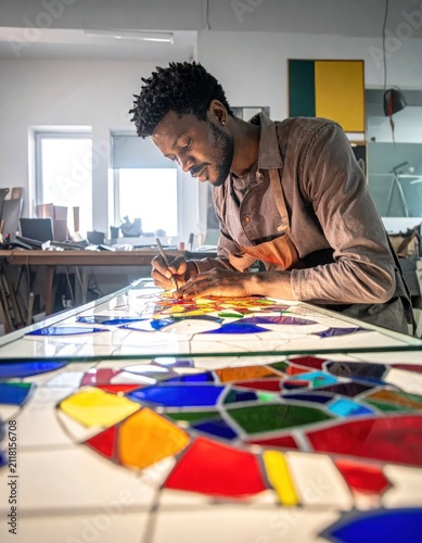 Artisan creating stained glass mosaic art.