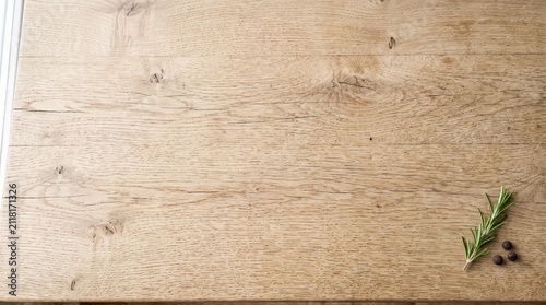 Quadro su tela Light Wood Background with Fresh Rosemary and Black Peppercorns