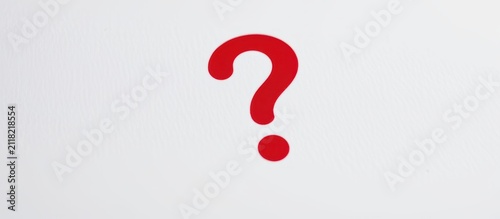 Red question mark symbol painted on a white textured background.