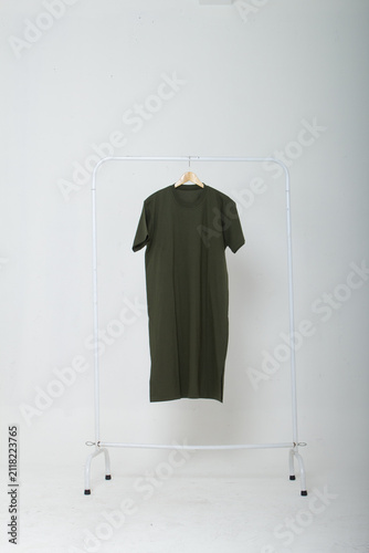 Photography Olive Green Long T-Shirt Dress Hanging on a White Clothing Rack
