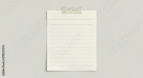 Blank lined notebook page with floral clip