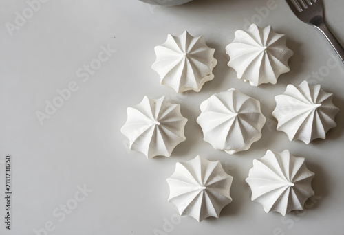 Six white meringue cookies ...