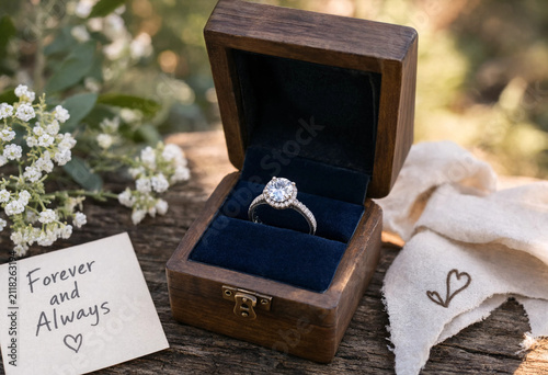 Wooden box holds a sparkling diamond ring