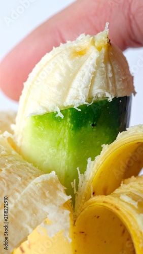 Surreal visual concept of a peeled banana revealing a green cucumber inside