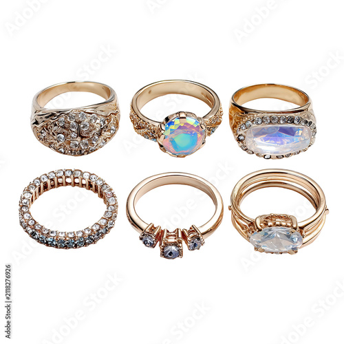 Six golden rings, each uniquely designed with precious stones and varying band styles, arranged in two rows