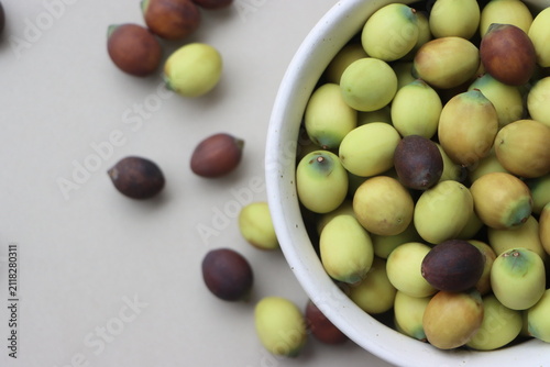 Fresh raw green lotus seeds, with edible kernels, harvested from an aquatic wetland
