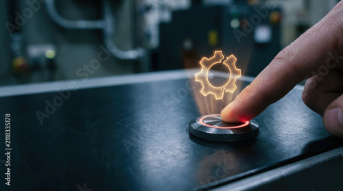Manufacturing halt on dark control panel as finger presses glowing button near gear icon