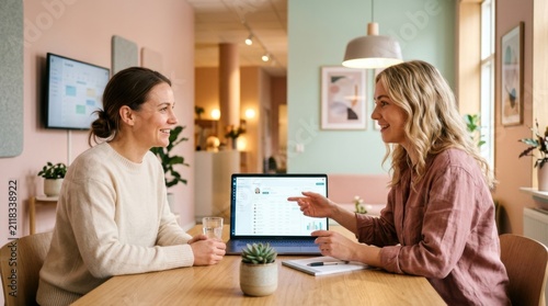 Business Meeting Discussing Data On Laptop Screen
