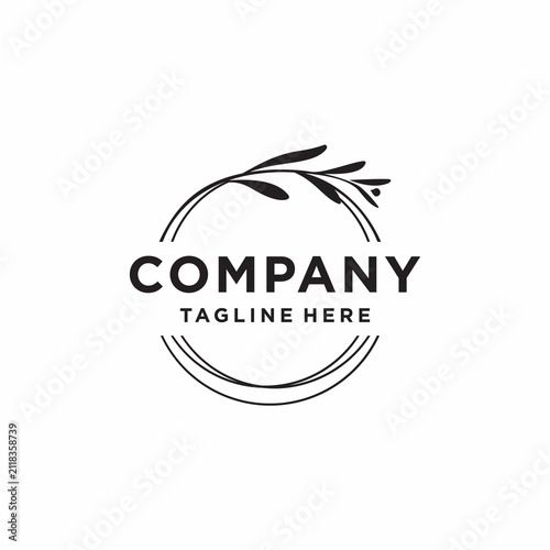 This logo features a minimalist and elegant design that combines elements of a twig with leaves at the top and an abstract circle formed from several thin lines.
